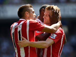 Steven Davis celebrates with Dusan Tadic during the Premier League game between Tottenham Hotspur and Southampton on May 8, 2016