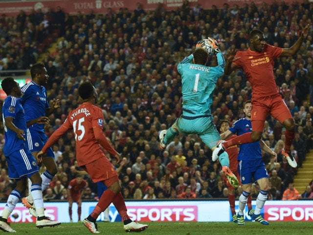 Chelsea goalkeeper Asmir Begovic collects a cross under pressure from Liverpool's Christian Benteke during the Premier League clash between the two sides on May 11, 2016