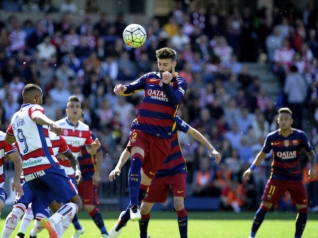 Big Gerard Pique heads the ball during the La Liga game between Granada and Barcelona on May 14, 2016