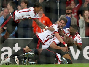Sunderland's players pile on in celebration of their third goal during the 3-0 win over Everton at the Stadium of Light on May 11, 2016