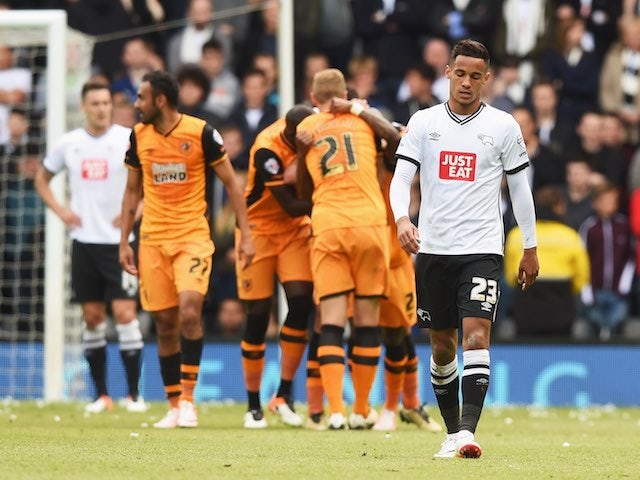 Tom Ince looks downbeat as Hull players celebrate their second goal during the Championship playoff semi-final between Derby County and Hull City on May 14, 2016