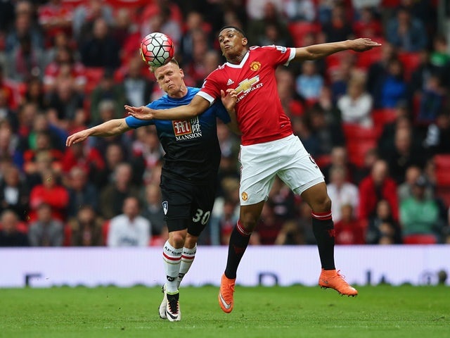 Anthony Martial of Manchester United and Matt Ritchie of Bournemouth battle for the ball at Old Trafford on May 17, 2016