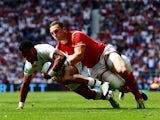 England winger Anthony Watson touches down despite the best efforts of Wales counterpart George North during the meeting between the two sides at Twickenham on May 29, 2016