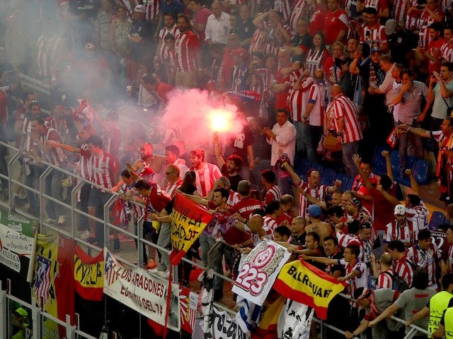 Atletico fans let off flares during the Champions League final between Real Madrid and Atletico Madrid on May 28, 2016