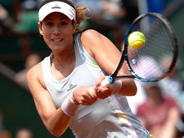 Garbine Muguruza returns the ball to Myrtille Georges during their women's second-round match at the French Open on May 25, 2016