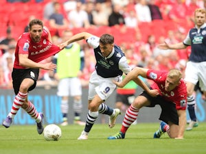 Millwall's Lee Gregory holds off the challenges of two Barnsley players during the League One playoff final at Wembley on May 29, 2016