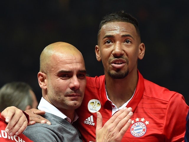 Pep Guardiola is hugged by Jerome Boateng after Bayern Munich defeated Borussia Dortmund in the DFB-Pokal final on May 21, 2016
