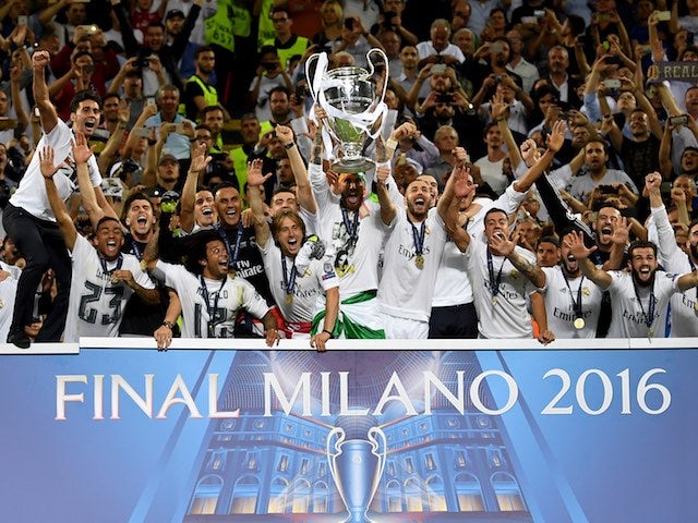 Real Madrid players celebrate with the trophy after the Champions League final between Real Madrid and Atletico Madrid on May 28, 2016