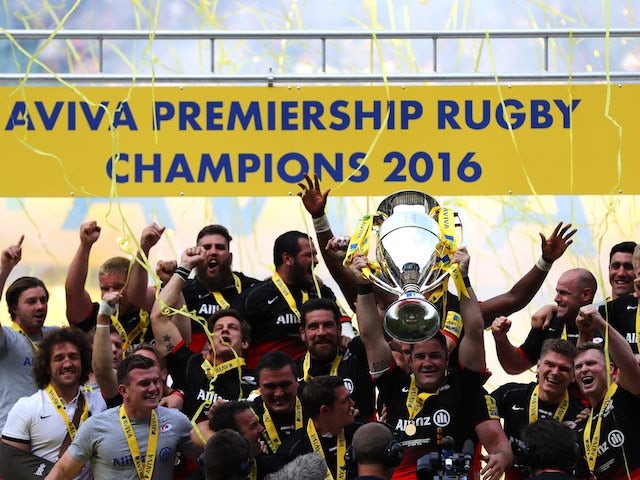Saracens players celebrate with the trophy after the Aviva Premiership final between Saracens and Exeter Chiefs on May 28, 2016