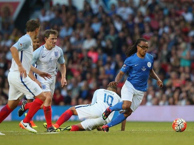 Edgar Davids of Rest of the World beats Marvin Humes of England during the Soccer Aid 2016 match in aid of UNICEF at Old Trafford on June 5, 2016