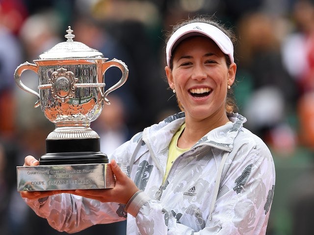 An agape Garbine Muguruza poses with the trophy after winning the French Open on June 4, 2016