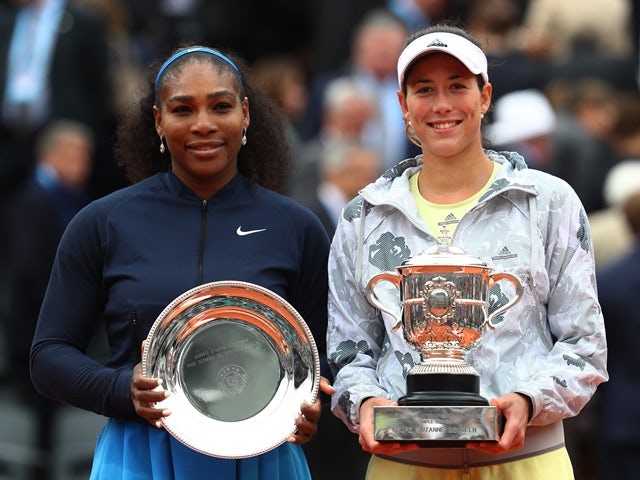 Serena Williams and champion Garbine Muguruza pose after the French Open final on June 4, 2016