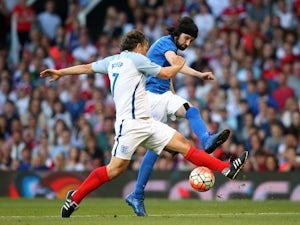 Sergio Pizzorno shoots past John Bishop during the Soccer Aid 2016 match in aid of UNICEF at Old Trafford on June 5, 2016
