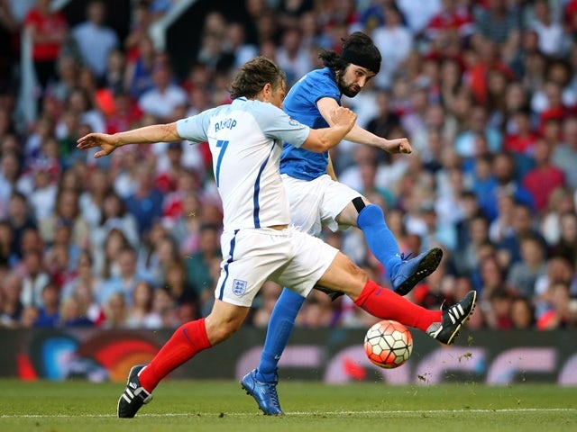 Sergio Pizzorno shoots past John Bishop during the Soccer Aid 2016 match in aid of UNICEF at Old Trafford on June 5, 2016