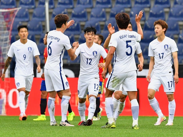 South Korea players celebrate after scoring during the friendly against Spain on June 1, 2016