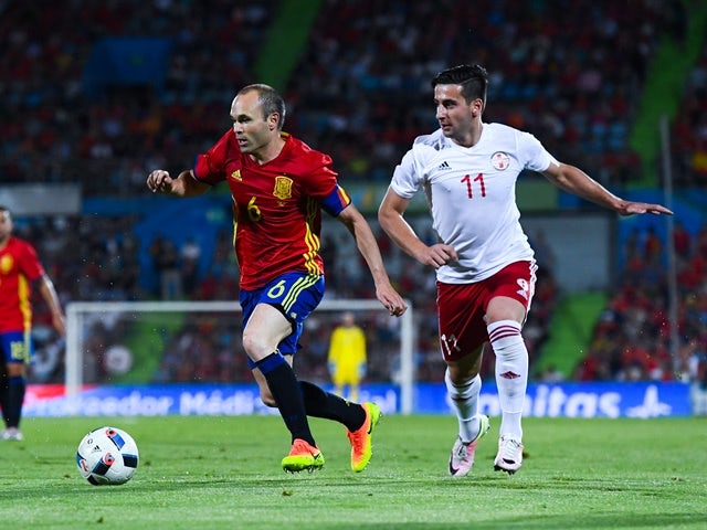 Andres Iniesta of Spain competes for the ball with Chanturia of Georgia during an international friendly on June 7, 2016