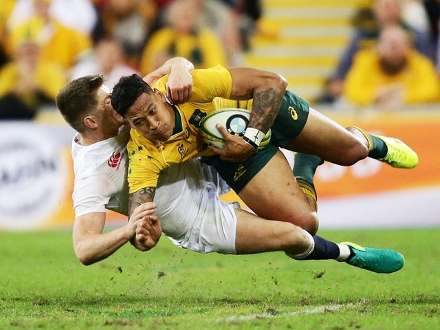 Israel Folau of Australia is tackled by Owen Farrell of England during the international Test match on June 11, 2016