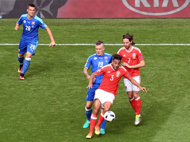 Slovakia's Juraj Kucka and Wales's Neil Taylor and Joe Allen in action at Euro 2016 on June 11, 2016