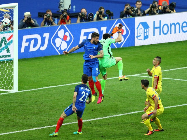  Olivier Giroud of France heads the ball to score his team's first goal during the UEFA Euro 2016 Group A match between France and Romania at Stade de France on June 10, 2016 in Paris, France