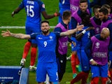 Olivier Giroud (1st L) of France celebrates scoring his team's first goal with his team mates during the UEFA Euro 2016 Group A match between France and Romania at Stade de France on June 10, 2016 in Paris, France