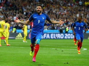 Olivier Giroud of France celebrates scoring his team's first goal during the UEFA Euro 2016 Group A match between France and Romania at Stade de France on June 10, 2016 in Paris, France