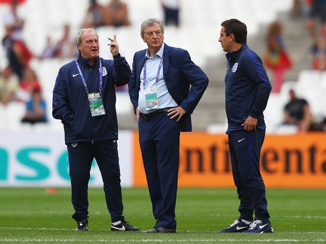 England manager Roy Hodgson speaks with his assistant coaches Ray Lewington and Gary Neville prior to kickoff against Russia on June 11, 2016