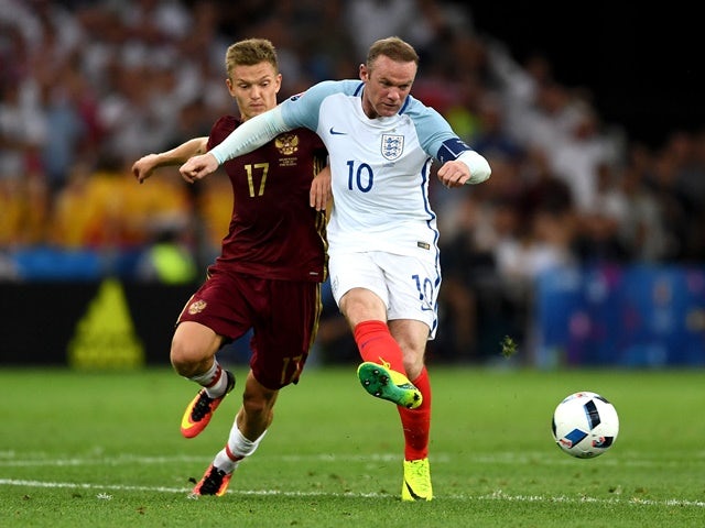 Wayne Rooney and Oleg Shatov compete for the ball during the Euro 2016 Group B game between England and Russia on June 11, 2016