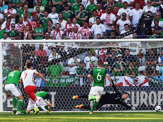 Arkadiusz Milik scores during the Euro 2016 Group C game between Poland and Northern Ireland on June 12, 2016