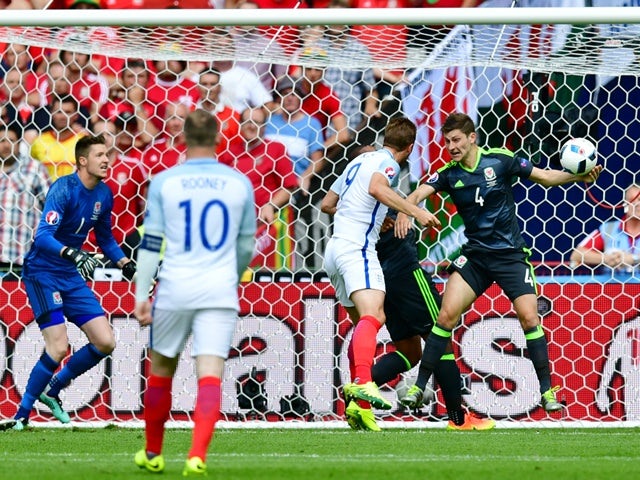 Ben Davies is hit in the arm by the ball during the Euro 2016 Group B game between England and Wales on June 16, 2016