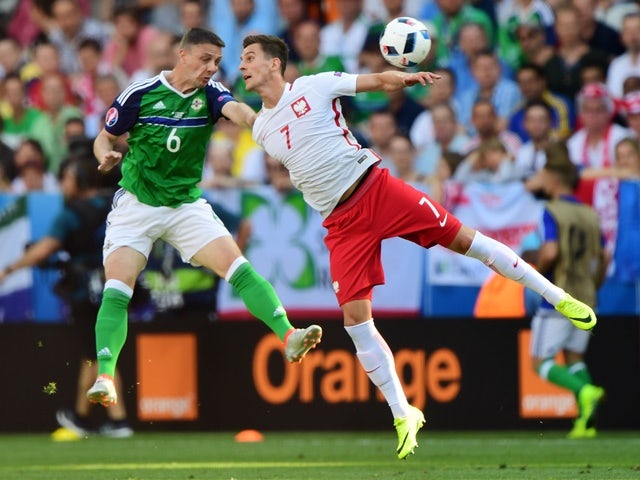 Chris Baird and Arkadiusz Milik during the Euro 2016 Group C game between Poland and Northern Ireland on June 12, 2016