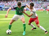Northern Ireland's defender Paddy McNair controls the ball as Poland's Bartosz Kapustka marks him on June 12, 2016