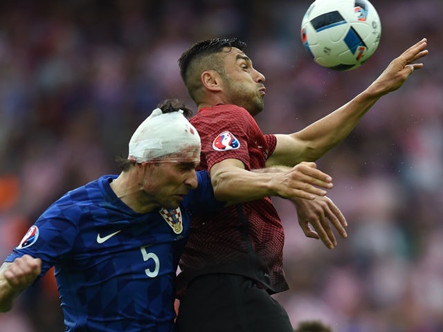 Vedran Corluka and Oguzhan Ozyakup during the Euro 2016 Group D game between Turkey and Croatia on June 12, 2016