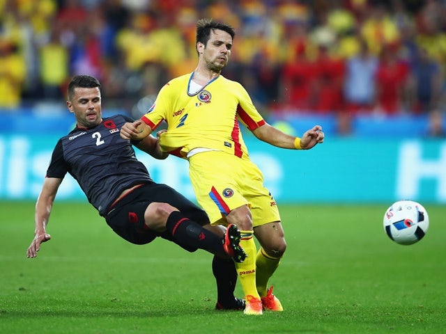 Alexandru Matel is tackled by Andi Lila during the Euro 2016 Group A match between Romania and Albania on June 19, 2016