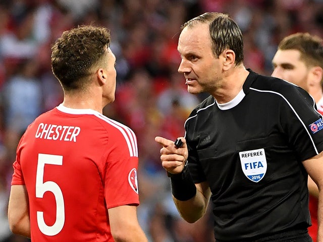 Referee Jonas Eriksson speaks to James Chester during the Euro 2016 Group B match between Russia and Wales on June 20, 2016