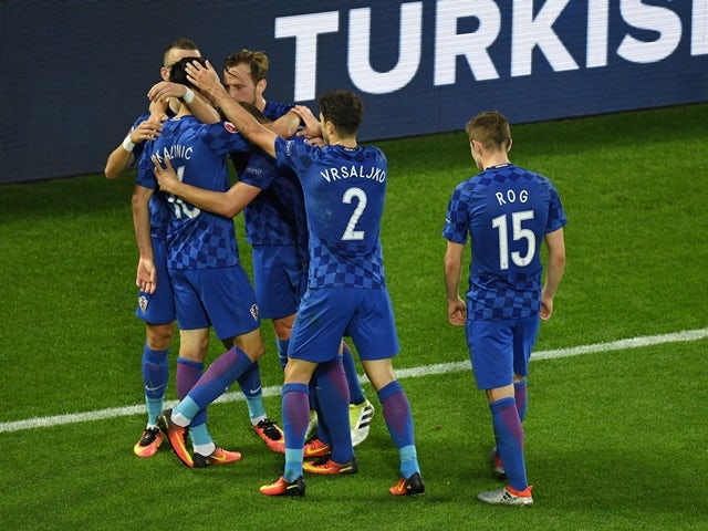 Nikola Kalinic celebrates scoring his team's first goal with his teammates during the Euro 2016 Group D match between Croatia and Spain on June 21, 2016