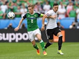 Steven Davis and Mesut Ozil in action during the Euro 2016 Group C match between Northern Ireland and Germany on June 21, 2016