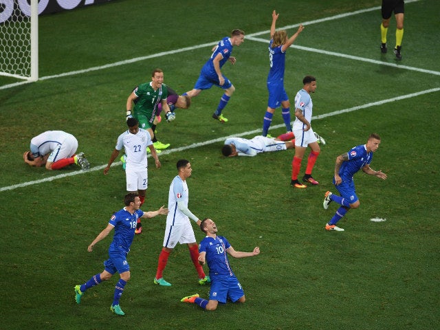 Iceland players celebrate while England players show dejection after the UEFA EURO 2016 round of 16 match between England and Iceland at Allianz Riviera Stadium on June 27, 2016 in Nice, France