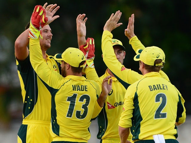 Nathan Coulter-Nile of Australia celebrate the wicket of Andre Fletcher of the West Indies with his team mates during the Tri-Nation Series One-day International (ODI) Final between West Indies and Australia at the Kensington Oval on June 26, 2016 