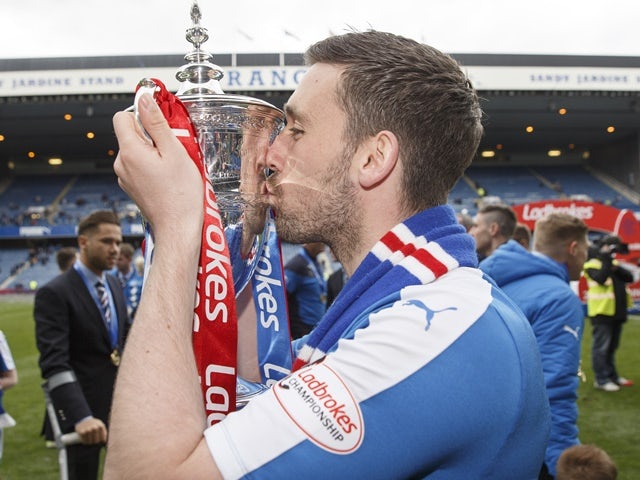 Nicky Clark lifts the Scottish Championship Trophy after the match between Rangers and Alloa Athletic at Ibrox Stadium on April 23, 2016