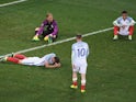 Wayne Rooney (2nd R) of England walks to console Gary Cahill (1st L), Joe Hart (2nd L) and Dele Alli (1st R) after their defeat in the UEFA EURO 2016 round of 16 match between England and Iceland at Allianz Riviera Stadium on June 27, 2016 in Nice, France