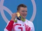 Adam Peaty holds his gold medal after the 100m breaststroke at the Rio Olympics on August 7, 2016