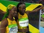 Shelly-Ann Fraser-Pryce and Elaine Thompson pose with the Jamaican flag after the women's 100m final on August 13, 2016