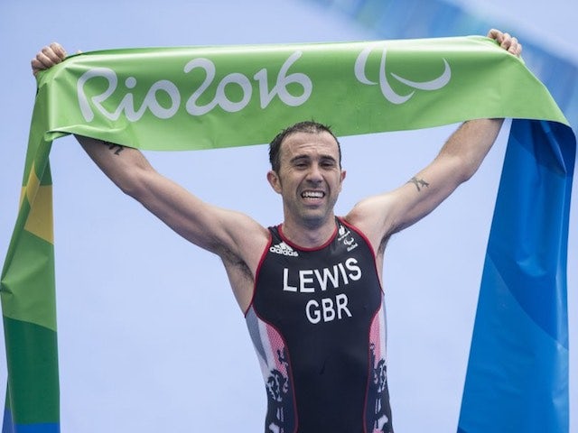 Andy Lewis celebrates winning gold in the men's triathlon at the Paralympic Games in Rio de Janeiro on September 10, 2016