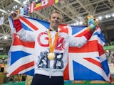 Jody Cundy poses with his gold medal and the GB flag after winning gold in the men's C4-5 1000m time trial event at the Paralympic Games in Rio de Janeiro on September 9, 2016