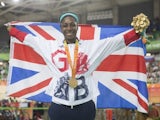 Kadeena Cox poses with her gold medal and the GB flag after winning the women's C4-5 500m time trial at the Paralympic Games in Rio de Janeiro on September 10, 2016