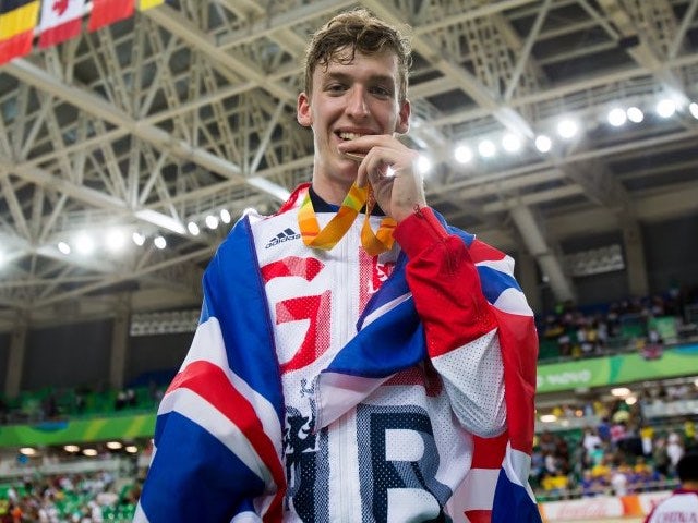 Louis Rolfe poses with his bronze medal and the GB flag after the men's C2 3000m pursuit event at the Paralympic Games in Rio de Janeiro on September 9, 2016