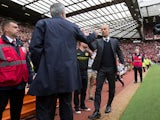 Manchester United manager Jose Mourinho and Manchester City boss Pep Guardiola shake hands before the derby at Old Trafford on September 10, 2016