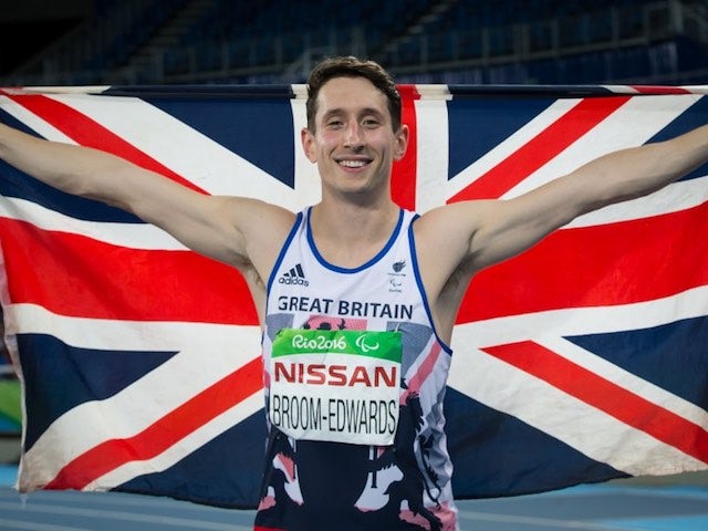 Jonathan Broom-Edwards celebrates with the GB flag after earning a silver medal in the men's high jump T44 at the Paralympic Games in Rio de Janeiro on September 12, 2016