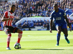 Southampton winger Nathan Redmond takes on Leicester City captain Wes Morgan during the Premier League meeting between the two sides at the King Power Stadium on October 2, 2016