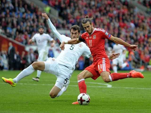 Georgia's Solomon Kvirkvelia dives in to tackle Wales's Gareth Bale during the 2018 World Cup Qualifier match on 9 October 2016